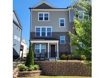 Charming townhouse with brick and siding exterior, featuring a well-maintained front yard at 1643 Wimberly Rd, Apex, NC 27523