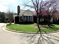 Charming brick home with lush green lawn and colorful flowering trees in a well-maintained neighborhood at 2002 Clyde Bank Ct, Cary, NC 27511