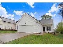 Charming one-story home featuring white siding, a spacious garage, and a well-manicured lawn at 2120 Castle Pines Dr, Raleigh, NC 27604