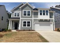 Charming two-story home with gray siding, white trim, and a two-car garage at 230 N Maple Walk Dr # 230, Garner, NC 27529