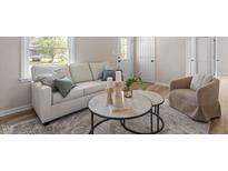 Cozy living room features a comfortable sofa, area rug, and stylish decor at 2304 Nelson St, Raleigh, NC 27610