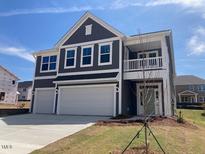 Charming two-story home with a covered porch, large windows, and a two-car garage at 245 N Maple Walk Dr # 219, Garner, NC 27529