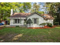 Charming single-story home with a well-manicured lawn, brick chimney, and inviting curb appeal at 3014 Hope Valley Rd, Durham, NC 27707