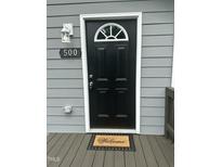 Inviting front entrance featuring a black door with a decorative window and a 'Welcome' mat at 500 John St St, Clayton, NC 27520