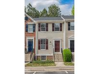 Charming townhouse featuring light siding, dark shutters, and a well-manicured front garden at 5507 Vista View Ct, Raleigh, NC 27612