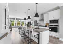 Bright, open kitchen with a large island, modern appliances, and stylish pendant lighting at 670 Bandon Aly, Cary, NC 27513