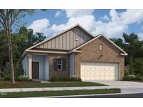 Charming brick and siding home with a two-car garage and manicured lawn at 821 Kenyon Spring Dr, Zebulon, NC 27597