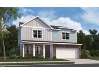 Charming two-story home featuring stone accents, neutral siding and an attached two-car garage at 845 Kenyon Spring Dr, Zebulon, NC 27597
