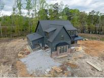 New construction home features dark siding, copper gutters and brick foundation at 8620 Dukes Lake Rd, Zebulon, NC 27597