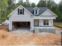Charming new construction with a two-car garage and bright, airy windows at 90 Purslane Dr, Franklinton, NC 27525