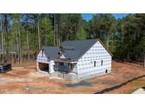 New construction home showing roof and first floor with house wrap and unfinished yard at 90 Purslane Dr, Franklinton, NC 27525