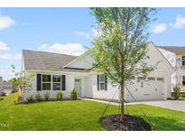 Charming single-story home with a manicured lawn and a light teal front door at 107 Port Charlotte Ct, Sanford, NC 27330
