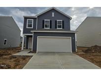 Charming two-story home with a two car garage and neutral gray siding and a concrete driveway at 131 N Keatts Winner Ct, Wilson's Mills, NC 27520
