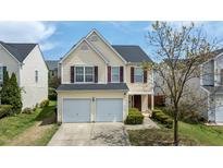 Charming two-story home with a two-car garage, mature trees, and well-maintained landscaping at 1533 Brown Owl Dr, Raleigh, NC 27610