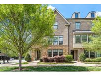 Charming brick townhome with stone accents and manicured landscaping at 1601 Bowery Dr, Raleigh, NC 27607