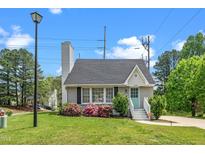 Charming single-story home featuring a well-manicured lawn, quaint front porch, and inviting light-blue front door at 2108 Quail View Trail, Raleigh, NC 27604