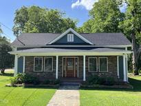 Charming single Gathering home with stone accents, inviting front porch, and well-manicured lawn at 223 E Nash St, Spring Hope, NC 27882