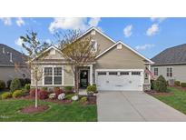 Charming single-Gathering home features a well-manicured lawn, two car garage and beautiful landscaping at 252 Tyree Trl, Burlington, NC 27215