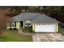 Charming single-Gathering home with a two-car garage, a well-manicured lawn and a cozy front porch at 3308 Venus Dr, Durham, NC 27703