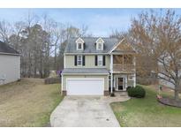 Charming two-story home with a two-car garage and a balcony on the front at 416 Collinsworth Dr, Clayton, NC 27527