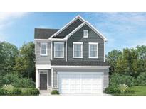 Charming two-story home with gray siding and a prominent two-car garage in a well-maintained community at 525 Morning Light Dr # 31, Angier, NC 27501
