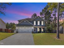 Charming two-story home featuring a two-car garage, and an inviting front porch perfect for enjoying quiet evenings at 78 Parkview Ln, Lillington, NC 27546