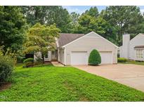 Charming home with a two-car garage, a well-maintained lawn, and mature landscaping at 227 Chimney Rise Dr, Cary, NC 27511