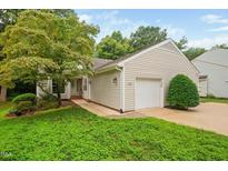 Charming one-story home featuring a one-car garage, neutral siding, and a well-manicured lawn at 227 Chimney Rise Dr, Cary, NC 27511