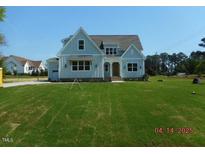 Charming home with a well-manicured lawn and a classic design, showcasing its curb appeal at 2617 Packhouse Rd, Zebulon, NC 27597