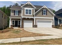 Charming two-story home with a two-car garage and stone accents on the facade at 280 N Maple Walk # 233, Garner, NC 27529