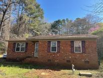 Charming brick home with a well-maintained lawn and traditional design at 3413 Renee Dr, Sanford, NC 27332