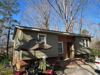 View of the home's exterior with a well maintained yard and fresh landscaping at 3414 Renee Dr, Sanford, NC 27332
