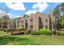 Inviting condo featuring well-maintained landscaping and a charming wooden walkway entrance at 3805 Chimney Ridge Pl # 003, Durham, NC 27713