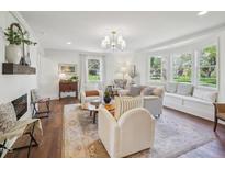 Bright living room featuring hardwood floors, a fireplace, and lots of natural light at 511 Circle Dr, Burlington, NC 27215