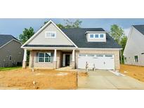 Charming brick home with a two-car garage and stylish gray shutters at 1073 Fairhaven Dr # 52, Mebane, NC 27302