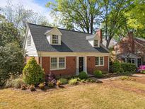Charming brick home featuring dormer windows and a well-manicured front yard at 119 Montgomery St, Raleigh, NC 27607