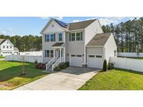 Charming two-story home featuring a two-car garage, fenced yard, and inviting front entrance at 1209 Huffington Oak Dr, Willow Springs, NC 27592