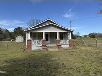 Charming single-story home featuring a covered front porch, and lawn at 1278 Valley Ct, Zebulon, NC 27597