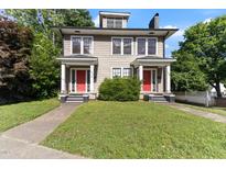Charming two-story duplex with matching red doors and a well-manicured front yard at 1308 Wake Forest Rd, Raleigh, NC 27604