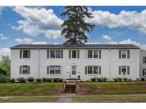 Inviting white brick exterior featuring gray shutters and a well-maintained lawn at 1700 W Front St # 36 D, Burlington, NC 27215