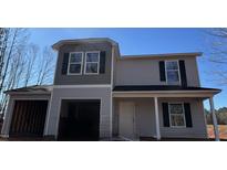 Two-story home featuring gray siding, black shutters and a covered front porch entry and garage at 2858 Stoney Creek Church Rd, Burlington, NC 27217