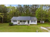 Charming single-story home with a well-manicured lawn and covered front porch at 5064 Murrell Dr, Oxford, NC 27565
