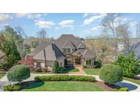 Stately brick home featuring a meticulously landscaped front yard and a grand entrance at 595 Legacy Falls N Dr, Chapel Hill, NC 27517