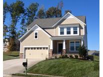 Charming two-story home featuring a craftsman-style design, attached garage, and well-manicured lawn, perfect for families at 810 Magnolia Acres Ln, Fuquay Varina, NC 27526