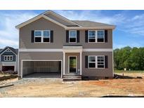 Charming two-story home with a two-car garage and classic architectural details in a developing neighborhood at 84 Grove Township Way, Angier, NC 27501
