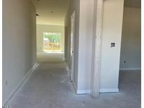 Bright hallway leading to a living area with deck access, offering a seamless indoor-outdoor transition at 84 Grove Township Way, Angier, NC 27501