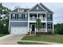 Charming two-story home featuring a welcoming porch and a well-manicured lawn at 103 Berry Mill Ln # 133, Raleigh, NC 27603
