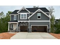 Charming two-story home featuring a modern gray exterior with stone accents and a spacious two-car garage at 108 Berry Mill Ln # 132, Raleigh, NC 27603
