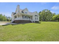 Charming home with a inviting front porch and well-manicured lawn, perfect for outdoor enjoyment at 1156 Darius Pearce Rd, Youngsville, NC 27596