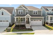 Charming two-story home with a covered front porch, two-car garage, and well-maintained lawn at 1245 Porters Call Dr, Wendell, NC 27591